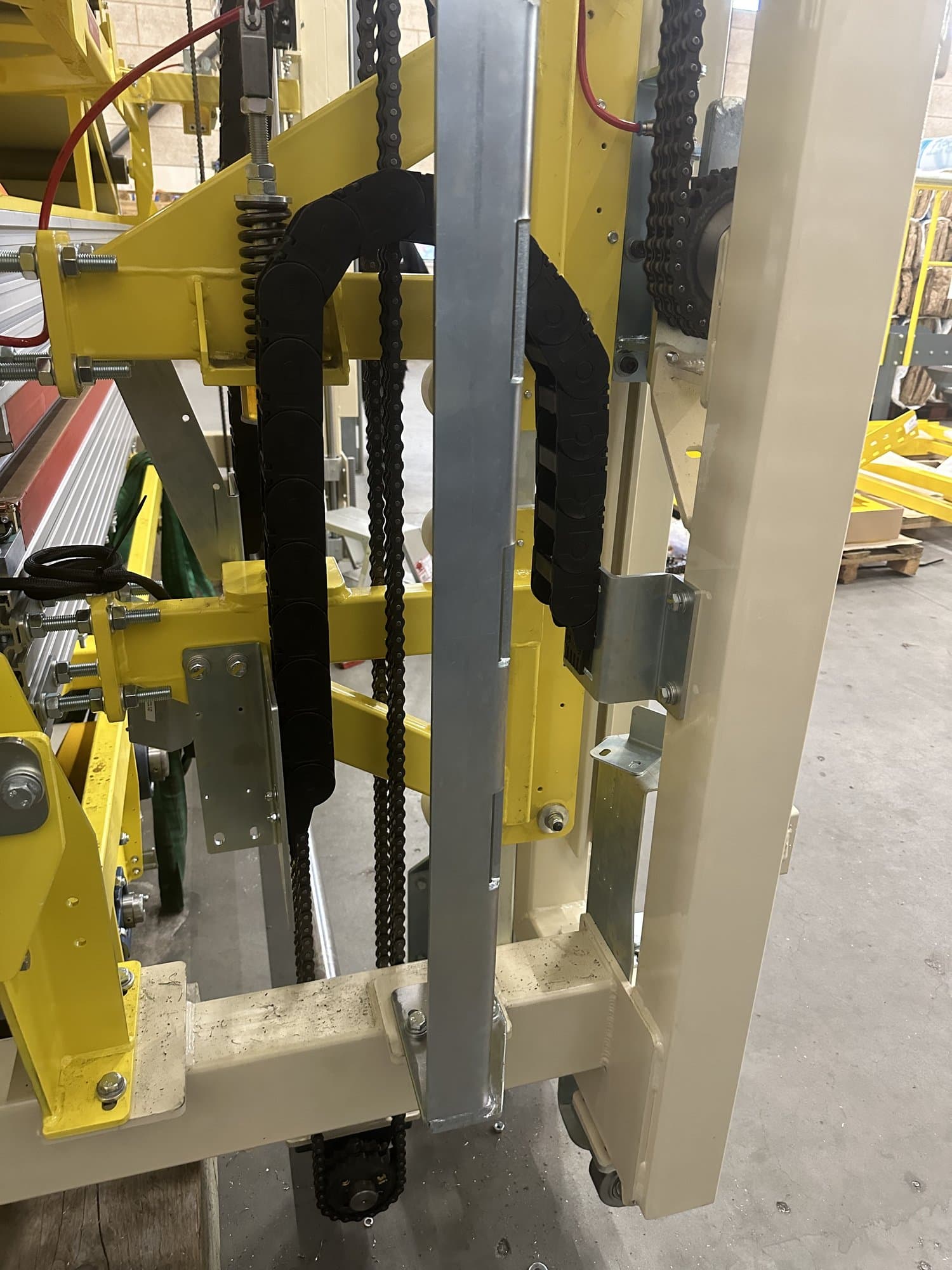 Chain and belt drive on an industrial conveyor system